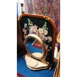 A needlework fire screen and a dressing table mirror.