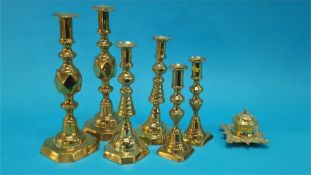 A small brass inkwell and three pairs of candlesticks. (7)