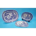 Four blue and white meat plates and a strainer dish.