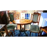 A Victorian oval table and a pair of oak chairs.