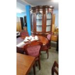 An Italian style dining room suite comprising; display cabinet, dining table and four chairs.
