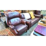 A good quality Ward leather three piece suite comprising; two reclining wing armchairs and a two