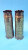 A pair of floral engraved brass shell cases.