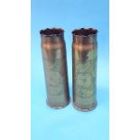 A pair of floral engraved brass shell cases.