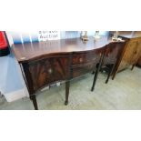 A reproduction mahogany serpentine front sideboard.