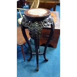 An Oriental hardwood pedestal, with marble inset and pierced fretwork to the sides. 32cm diameter