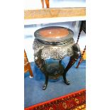 An Oriental design ebonised plant pedestal. 57cm diameter