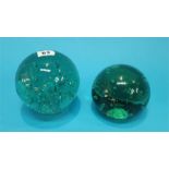 Two Victorian green glass door stops with bubbles.