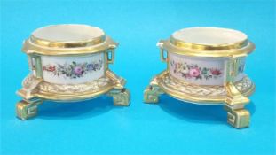 A pair of Continental porcelain stands, decorated with flowers and having Greek key feet. 9cm high