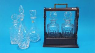 A modern tantalus and three glass decanters.