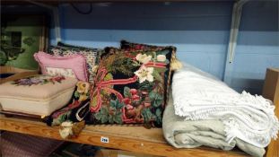 A needlework stool, scatter cushions and two bed spreads.
