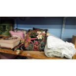 A needlework stool, scatter cushions and two bed spreads.