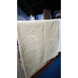 A pale cream Durham quilt.