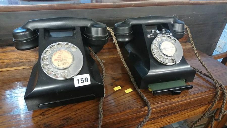 Two Bakelite telephones.