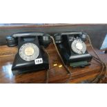 Two Bakelite telephones.