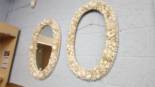 A seashell framed mirror and another seashell frame.