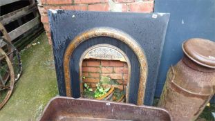 A cast iron fire surround.