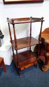 A 19th century rosewood three tier what not with single drawer. 53cm wide