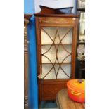 A mahogany inlaid corner display cabinet.