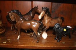 A Royal Doulton dog and three Beswick horses