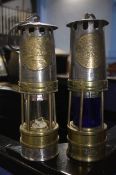 Two Ackroyd miners lamps