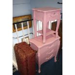 A pink chest of drawers, matching bedside drawers