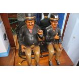 A figure group 'Laurel and Hardy' sat on bench