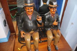 A figure group 'Laurel and Hardy' sat on bench