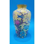 A Chinese vase on a yellow ground, decorated with birds and apple blossoms, painted red marks to