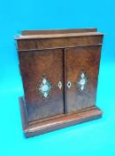 A Victorian walnut and mother of pearl inlaid work box, with rising top, below two doors, opening to