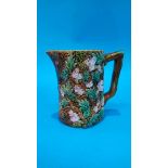 A Majolica jug, decorated with blossom