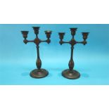 A pair of oak three sconce candlesticks