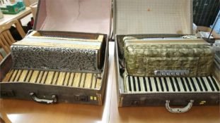 Two cased accordions