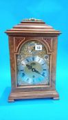 A good quality reproduction walnut mantle clock, the movement signed Elliot, London, retailed by