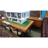 A teak sideboard, dining table and four chairs