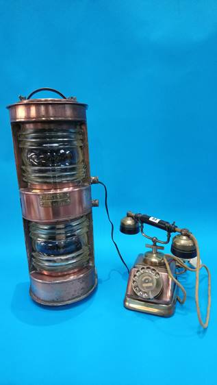 An Akter brass and copper Ship's light and an old brass and copper telephone