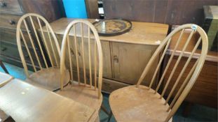A set of four Ercol hoop back chairs