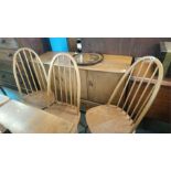 A set of four Ercol hoop back chairs