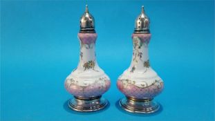 A pair of porcelain salt and pepper, with sterling silver mounts