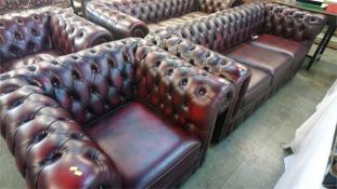 An Oxblood Chesterfield tub chair and a three seater settee