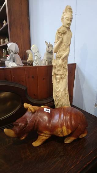 Carved hippo and a cast figure