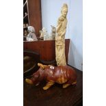 Carved hippo and a cast figure
