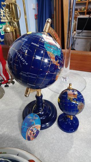 Two globes set with semi precious stones