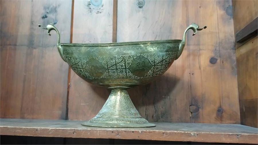 A Middle Eastern brass bowl