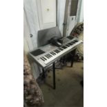 A Roland keyboard and stand