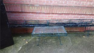 A metalwork table and two garden planters