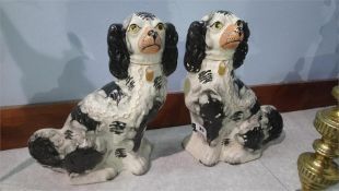 A pair of Staffordshire black and white spaniels