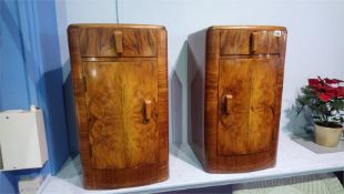 A pair of Art Deco style walnut bedside cabinets