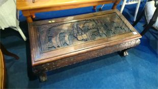 An Oriental carved low coffee table