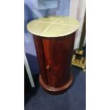 A mahogany circular bedside cabinet